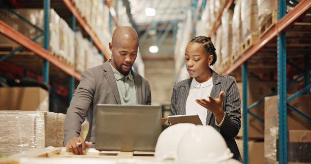 A man and a woman looking for tech stack for managing logistics